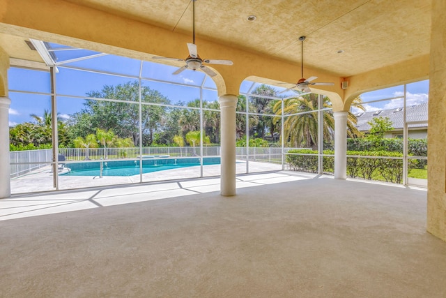 view of pool with ceiling fan, a patio, and a lanai
