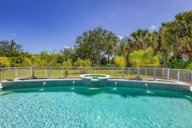 view of swimming pool with fence, central air condition unit, and a pool with connected hot tub