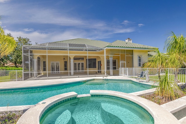 view of pool with french doors, fence, a ceiling fan, a pool with connected hot tub, and a patio