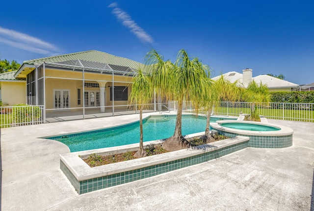 view of pool featuring a patio area, french doors, fence, and a pool with connected hot tub