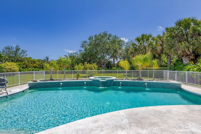 view of pool featuring fence, central AC unit, and a pool with connected hot tub