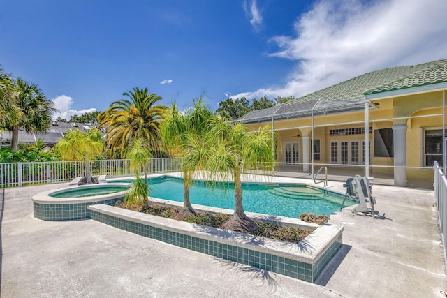 view of swimming pool with french doors, an in-ground hot tub, a patio area, fence, and a ceiling fan