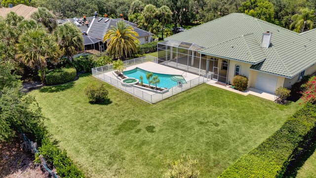 view of swimming pool with a lanai, a pool with connected hot tub, and a patio