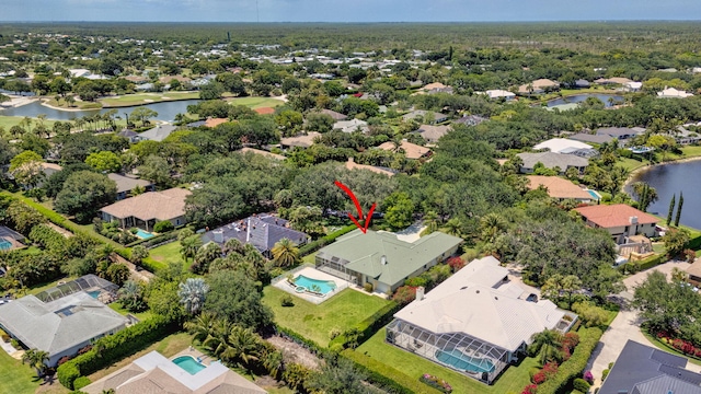aerial perspective of suburban area with a nearby body of water and a pool