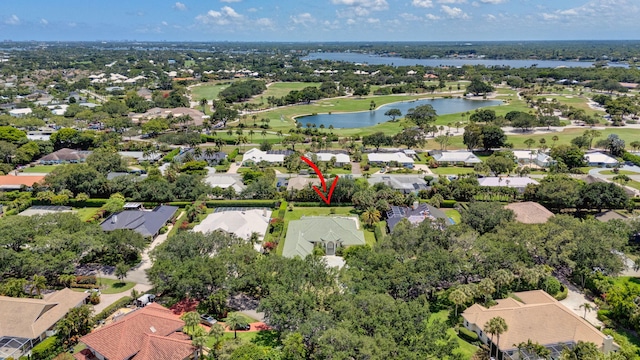 aerial view of residential area with a nearby body of water and a golf course