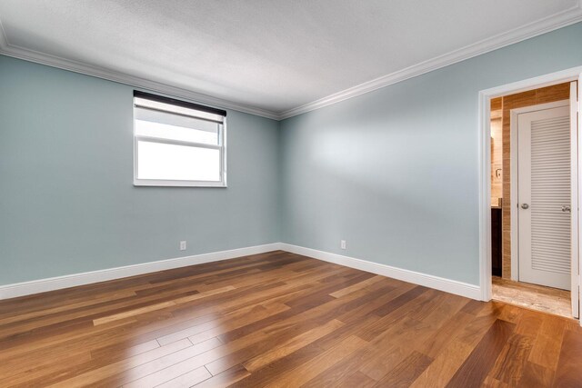 1 S Lakeside Dr Unit C1, Lake Worth Beach, FL 33460 - unfurnished bedroom with crown molding, baseboards, and wood finished floors