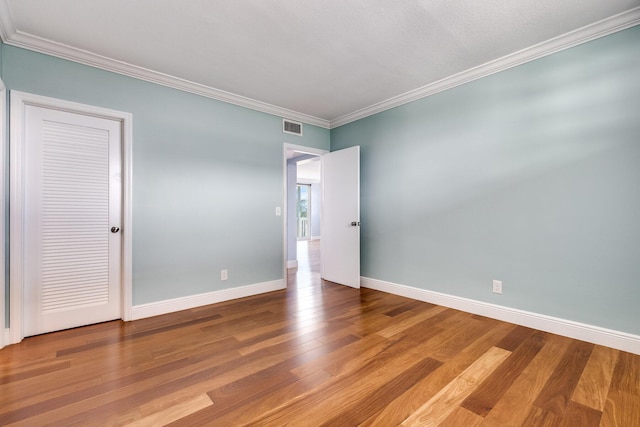 1 S Lakeside Dr Unit C1, Lake Worth Beach, FL 33460 - spare room featuring crown molding, baseboards, visible vents, and wood finished floors