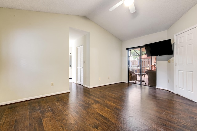 spare room with vaulted ceiling, ceiling fan, wood finished floors, and baseboards