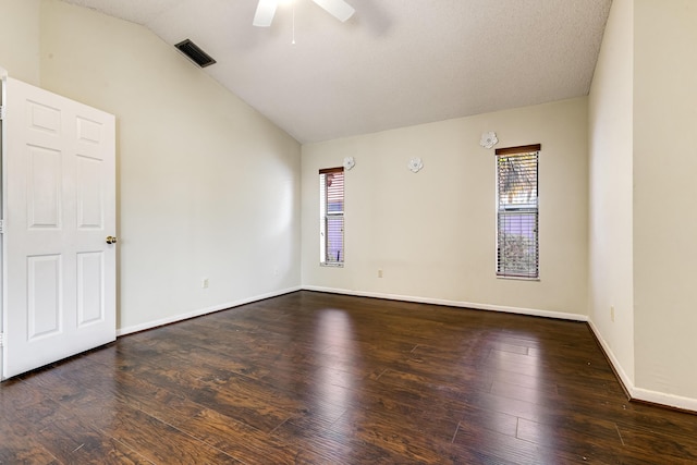 empty room featuring vaulted ceiling, ceiling fan, hardwood / wood-style flooring, and baseboards