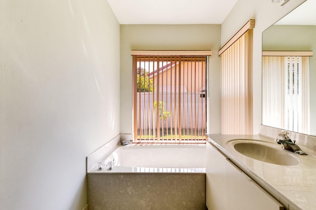 full bathroom with vanity and a bath