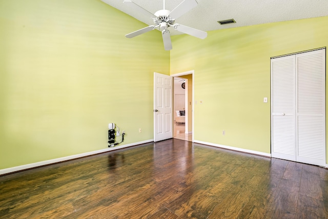 unfurnished bedroom with vaulted ceiling, wood finished floors, baseboards, a closet, and a ceiling fan