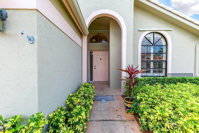 doorway to property with stucco siding