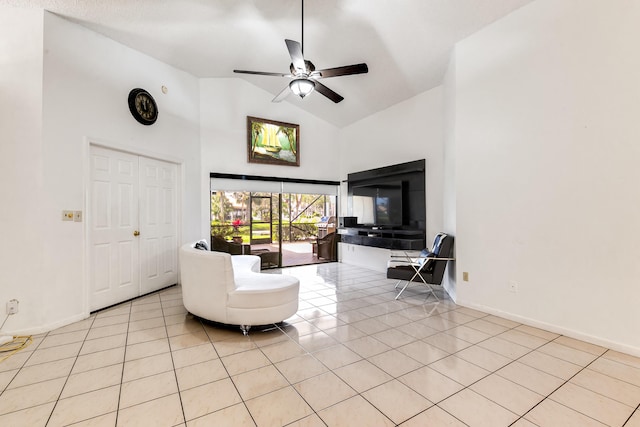 living room with high vaulted ceiling, light tile patterned flooring, a ceiling fan, and baseboards