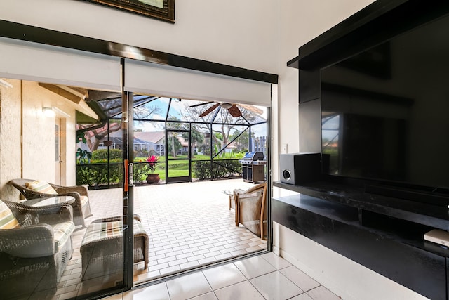 tiled living area with a sunroom and a ceiling fan