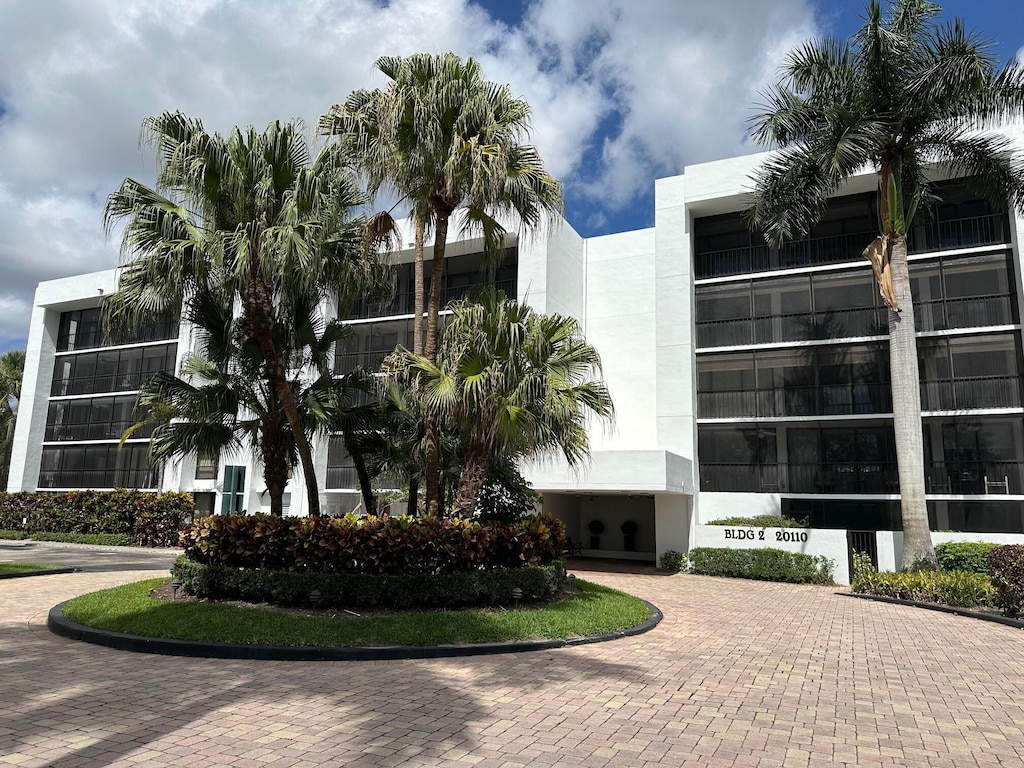 view of property with curved driveway