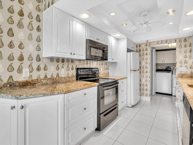 20110 Boca W Dr Unit 232, Boca Raton, FL 33434 - kitchen featuring light tile patterned flooring, black appliances, separate washer and dryer, white cabinets, and wallpapered walls