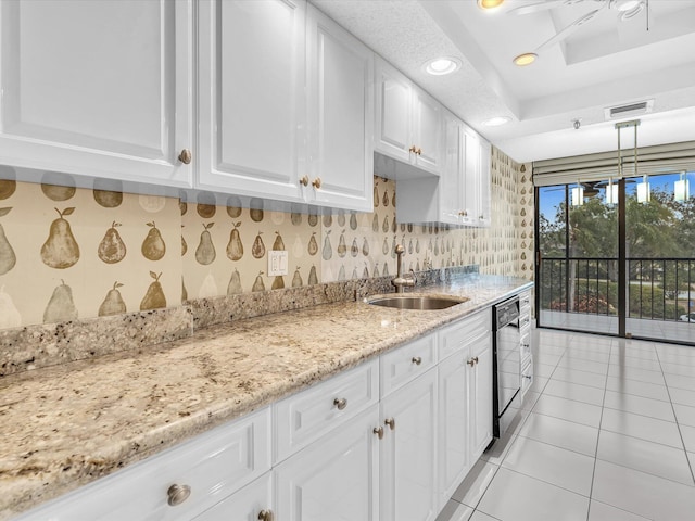 20110 Boca W Dr Unit 232, Boca Raton, FL 33434 - kitchen featuring a sink, light stone counters, dishwashing machine, visible vents, and white cabinetry