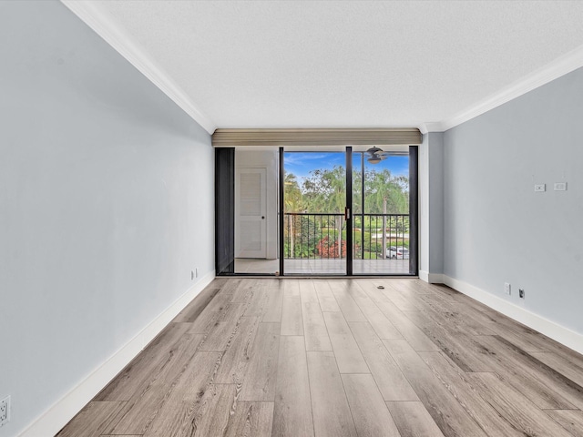 20110 Boca W Dr Unit 232, Boca Raton, FL 33434 - spare room with crown molding, wood finished floors, and baseboards