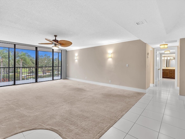 20110 Boca W Dr Unit 232, Boca Raton, FL 33434 - unfurnished living room with a ceiling fan, baseboards, light tile patterned floors, visible vents, and a wall of windows