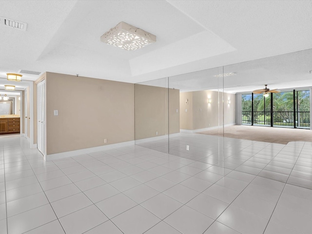 20110 Boca W Dr Unit 232, Boca Raton, FL 33434 - unfurnished room with light tile patterned floors, visible vents, and baseboards
