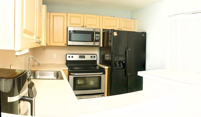 3500 Briar Bay Blvd Unit 106, West Palm Beach, FL 33411 - kitchen featuring appliances with stainless steel finishes, light brown cabinets, a sink, and light countertops