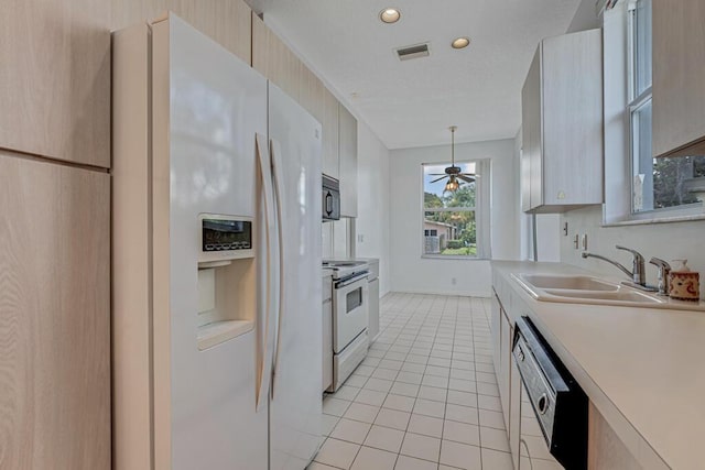 1501 Lee Ct, Lake Worth, FL 33461 - kitchen with white refrigerator with ice dispenser, dishwashing machine, electric range oven, light countertops, and light tile patterned floors