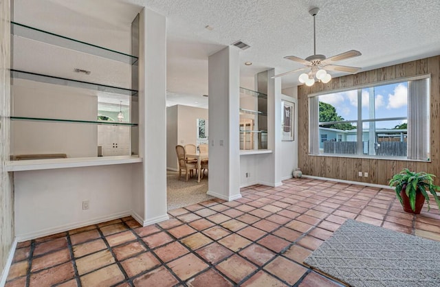 1501 Lee Ct, Lake Worth, FL 33461 - interior space featuring a ceiling fan, a textured ceiling, and wooden walls