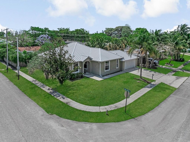 1501 Lee Ct, Lake Worth, FL 33461 - view of front facade featuring an attached garage, driveway, a front lawn, and stucco siding