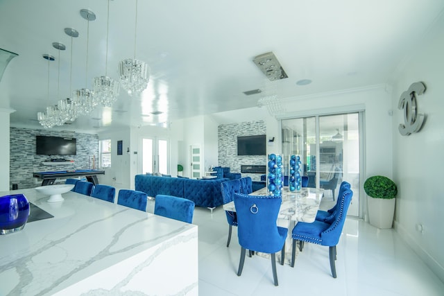 4941 SW 150th Ter, Miramar, FL 33027 - dining space with french doors, a glass covered fireplace, crown molding, light tile patterned floors, and baseboards