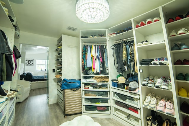 4941 SW 150th Ter, Miramar, FL 33027 - spacious closet with wood finished floors and a chandelier