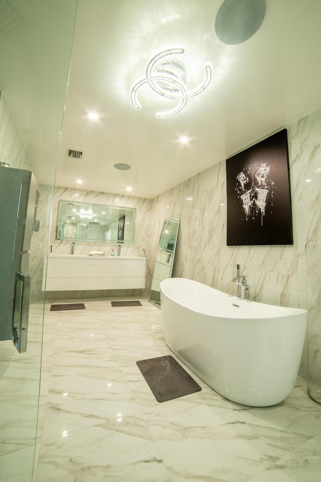 4941 SW 150th Ter, Miramar, FL 33027 - bathroom featuring marble finish floors, a freestanding bath, a shower with door, and vanity