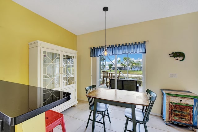 dining area featuring light tile patterned floors and baseboards