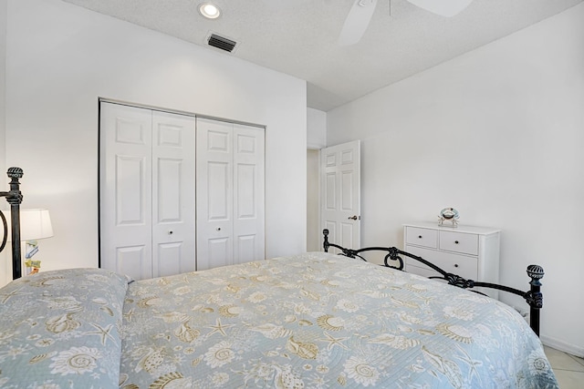 bedroom featuring ceiling fan, a closet, and visible vents