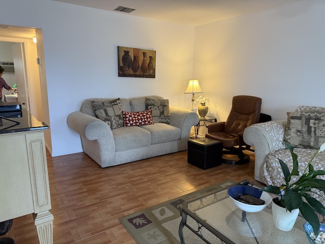 living room with visible vents and wood finished floors