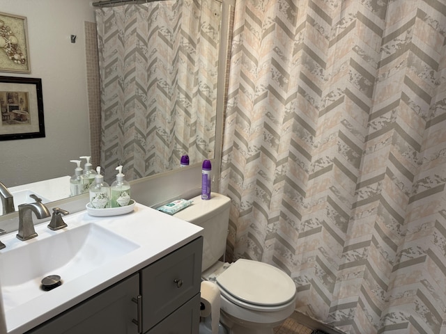 bathroom with toilet, vanity, and a shower with curtain