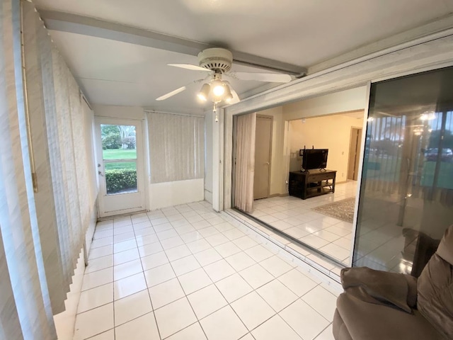 empty room featuring a ceiling fan, tile patterned flooring, and wallpapered walls