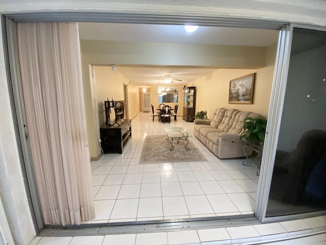 living room with tile patterned floors and a ceiling fan