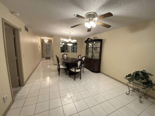 dining space with a chandelier, a textured ceiling, a ceiling fan, and light tile patterned floors
