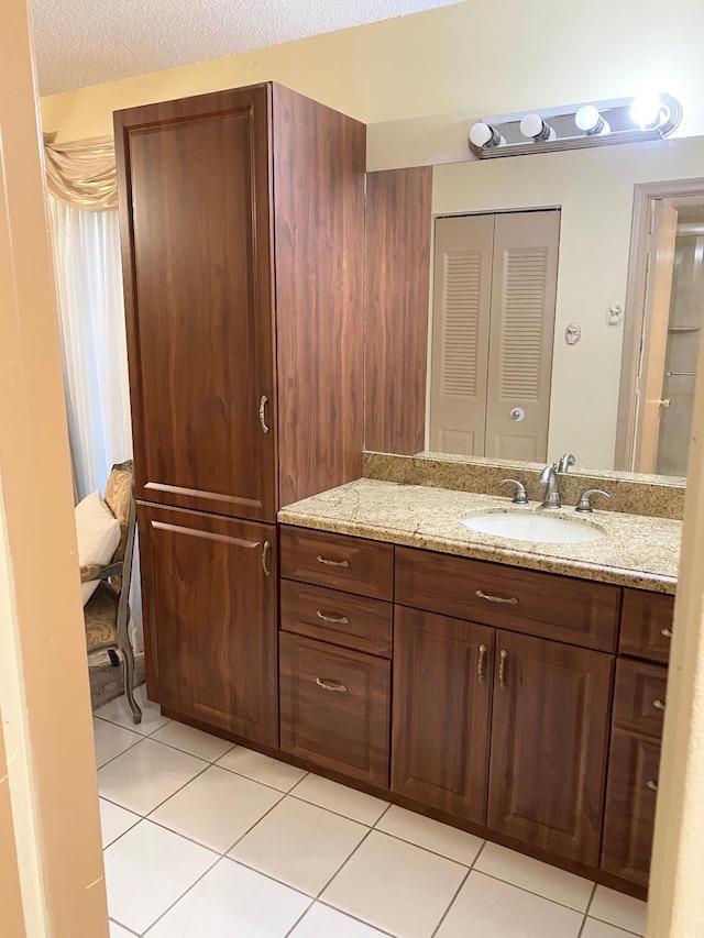 bathroom with tile patterned flooring and vanity