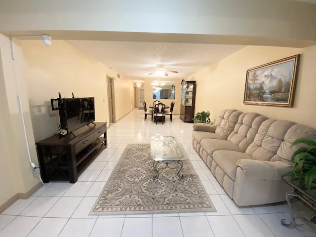 living area featuring light tile patterned floors and a ceiling fan