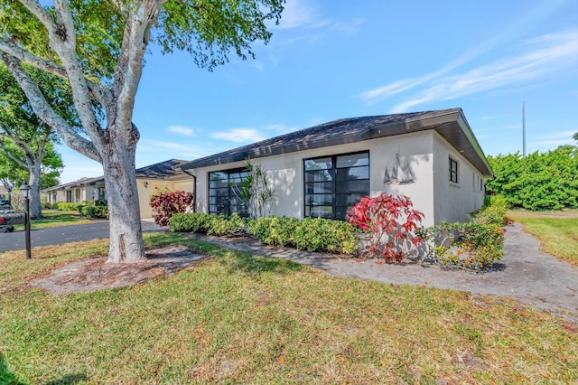 4875 Hawkwood Rd Unit B, Boynton Beach, FL 33436 - view of front of property with a front lawn and stucco siding