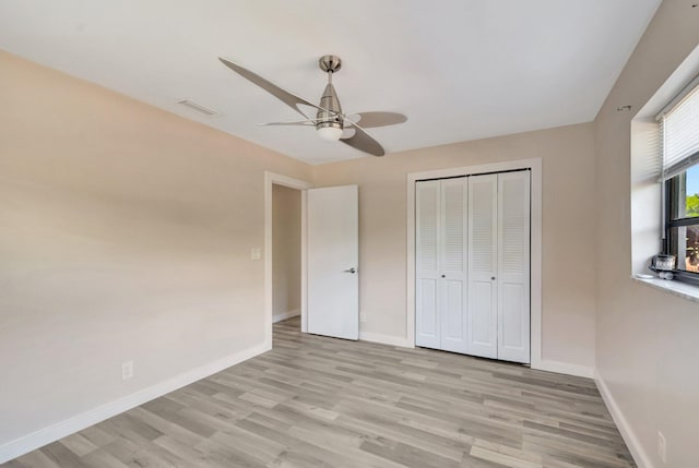 4875 Hawkwood Rd Unit B, Boynton Beach, FL 33436 - unfurnished bedroom featuring a ceiling fan, a closet, visible vents, baseboards, and light wood-style floors