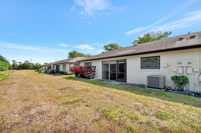 4875 Hawkwood Rd Unit B, Boynton Beach, FL 33436 - rear view of property featuring a yard, central AC unit, and stucco siding
