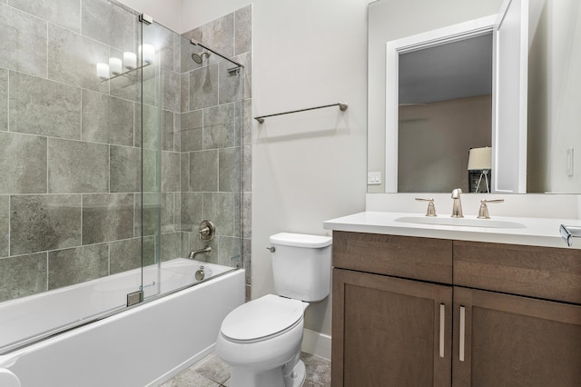 full bath with vanity, combined bath / shower with glass door, baseboards, and toilet