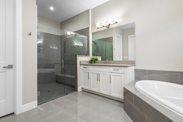 bathroom with a garden tub, vanity, and a shower stall
