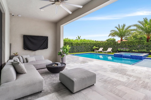 view of swimming pool featuring a ceiling fan, an outdoor living space, fence, a pool with connected hot tub, and a patio area