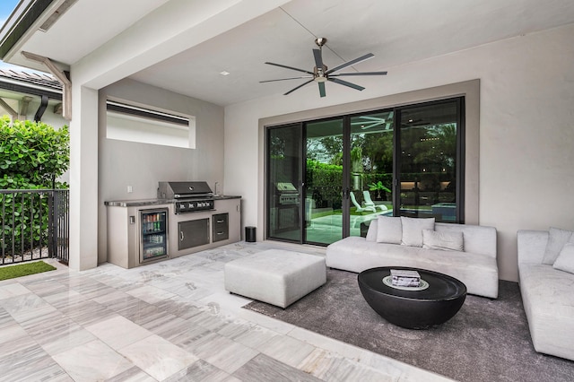 view of patio with grilling area, an outdoor kitchen, wine cooler, ceiling fan, and an outdoor living space