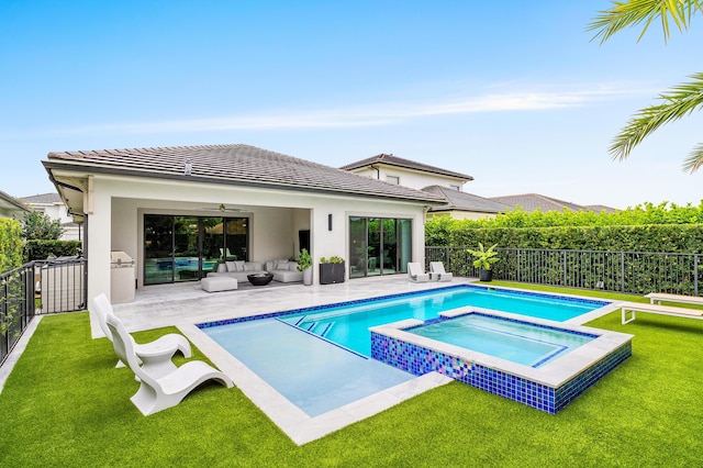 view of pool with an outdoor hangout area, a yard, ceiling fan, and a fenced backyard