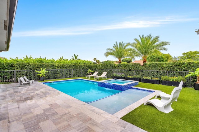 view of swimming pool with a yard, a pool with connected hot tub, a fenced backyard, and a patio