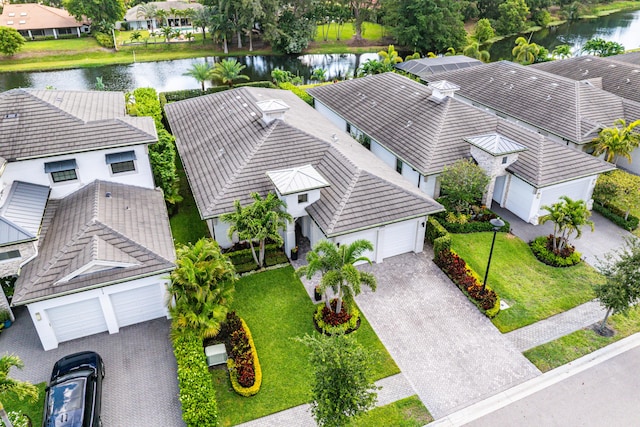 aerial perspective of suburban area with a nearby body of water